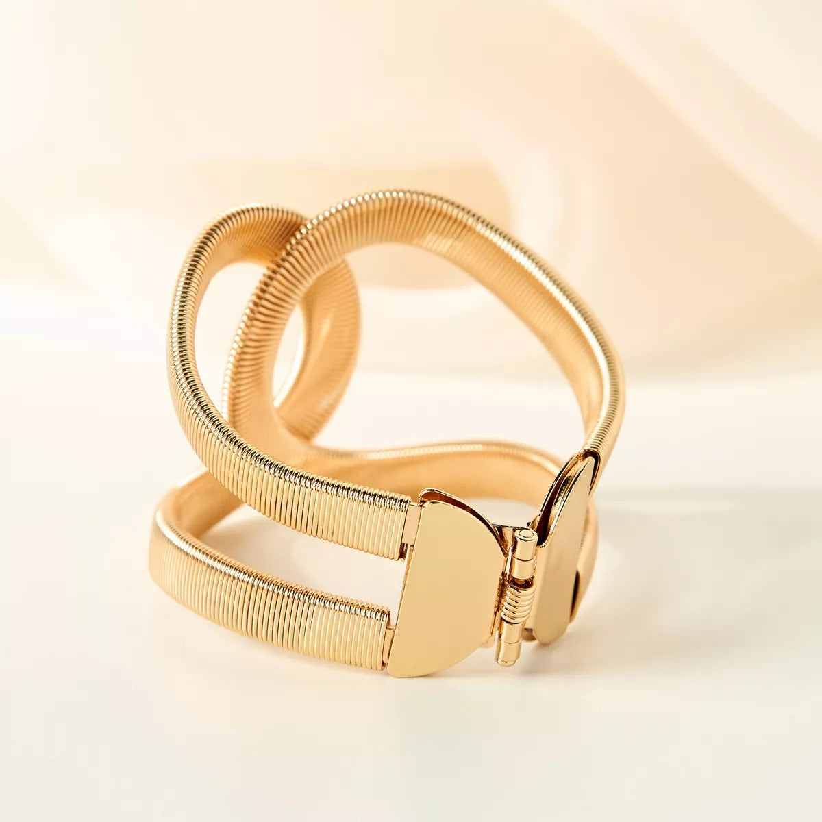 Elegant Gold Twist Cuff Bracelet — a modern statement jewelry piece featuring a unique wave design that blends sophistication with contemporary style.