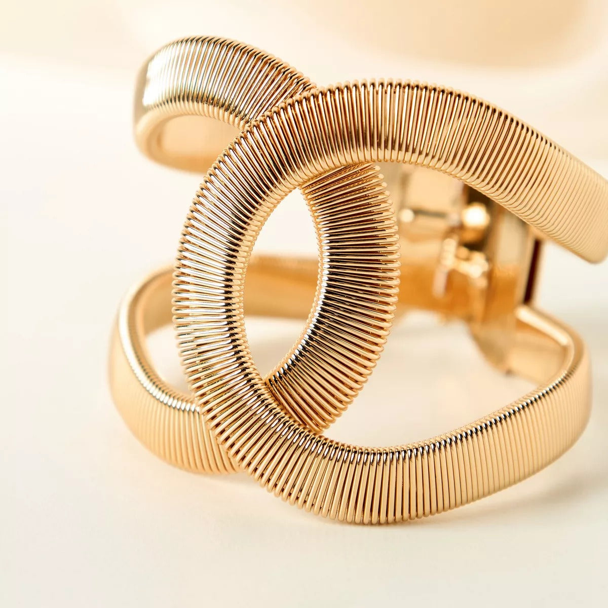 Elegant Gold Twist Cuff Bracelet — a modern statement jewelry piece featuring a unique wave design that blends sophistication with contemporary style.