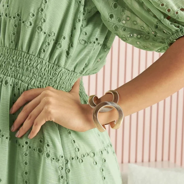 Elegant Gold Twist Cuff Bracelet — a modern statement jewelry piece featuring a unique wave design that blends sophistication with contemporary style.